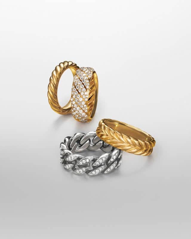 Four David Yurman bracelets in silver and gold.