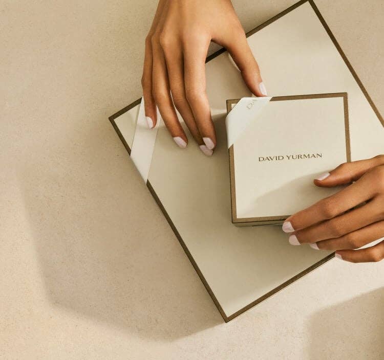 Woman's hands holding David Yurman Gift Box.
