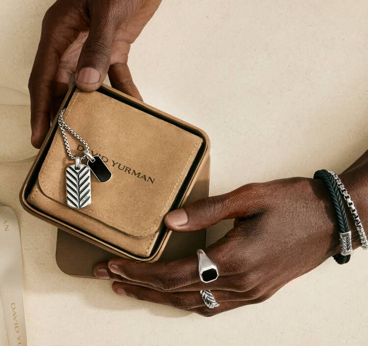 Man's hands holding David Yurman Gift Box.