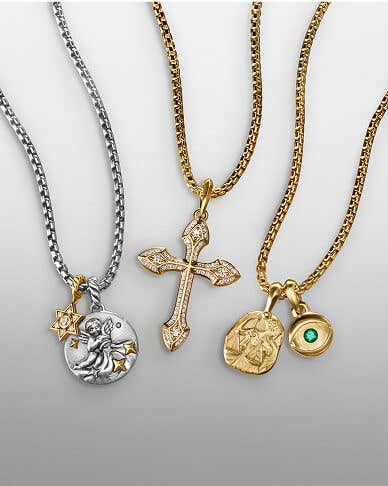 A variety of David Yurman charms and amulets for men and women on gold and silver chains.