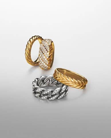A variety of David Yurman rings in gold and silver.
